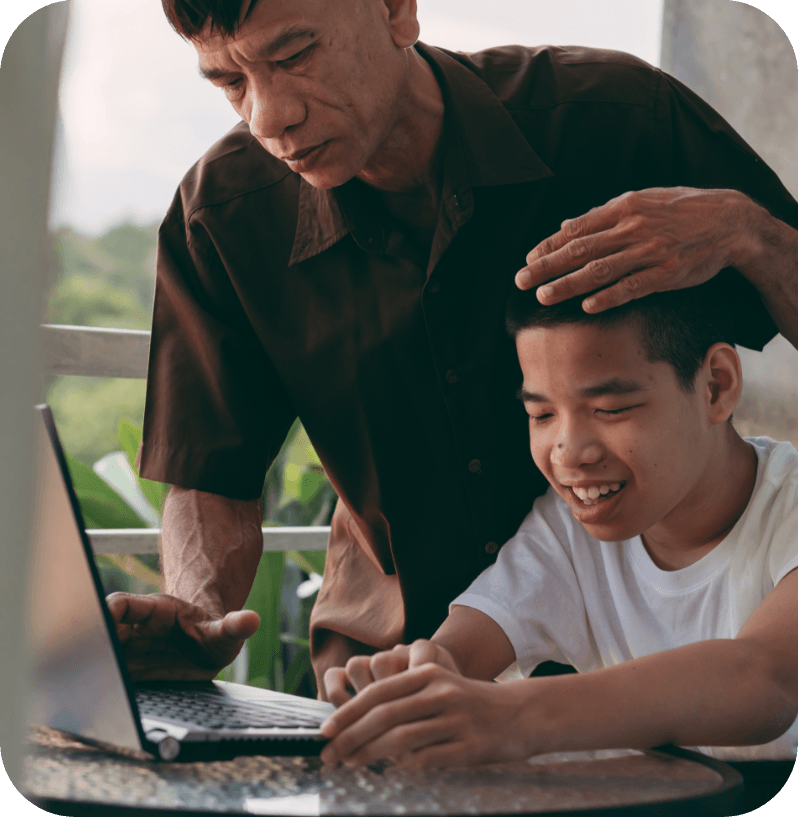 parent helps child on computer