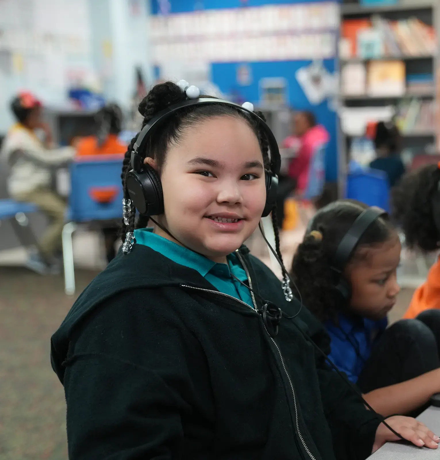 Young girl wearing headphones looking at the camera
