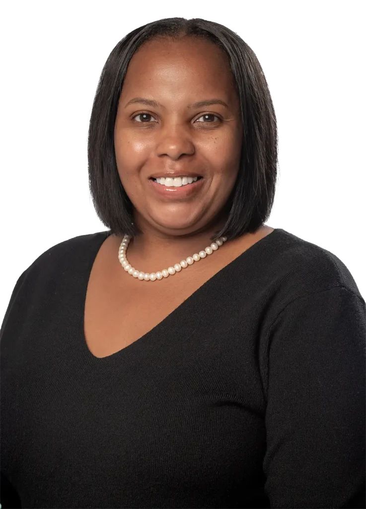 Davida Huntley in a black v-neck sweater and pearl necklace